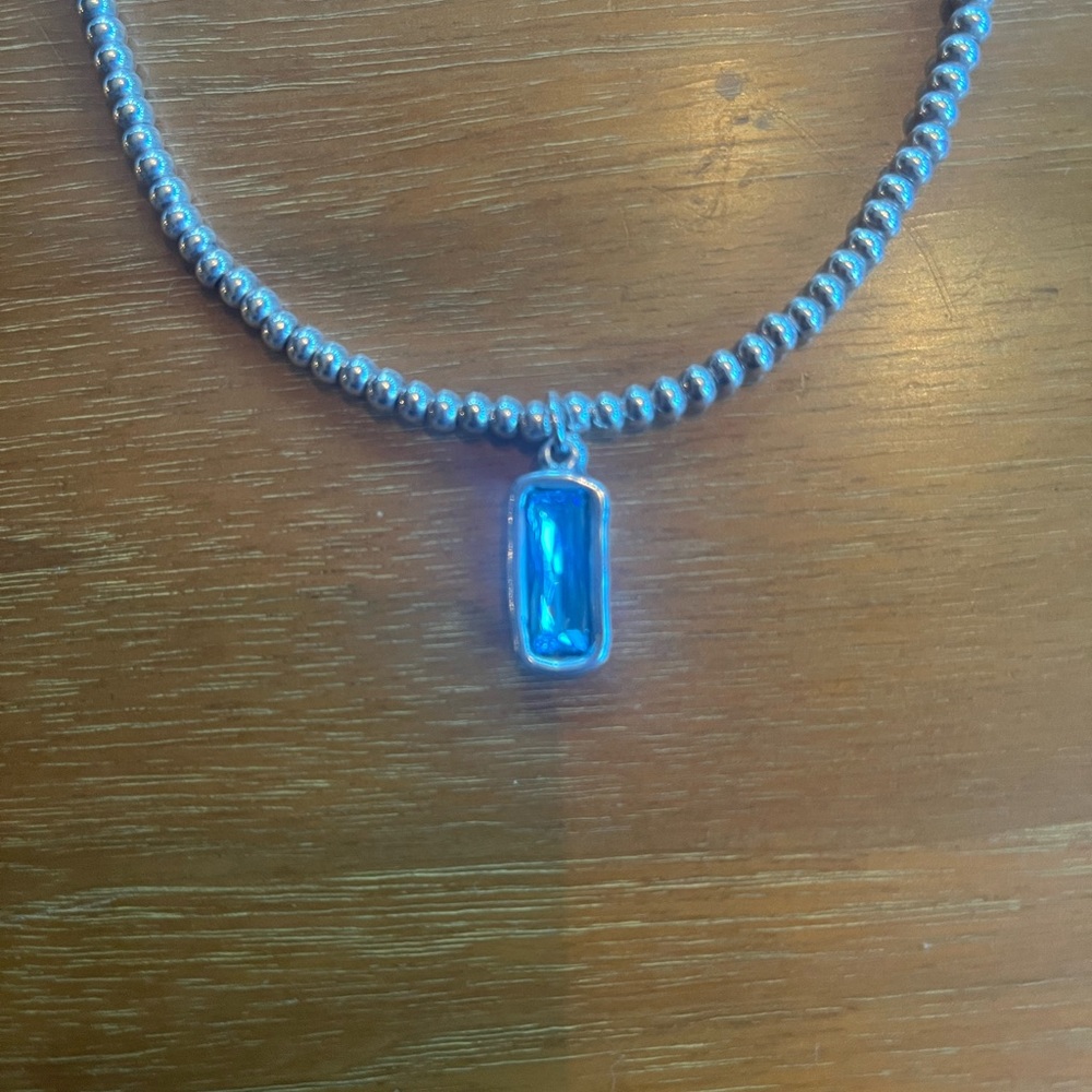 Uno de 50 bead necklace with blue crystal stone